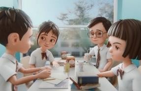 Leon and classmates gathered around a desk in the classroom